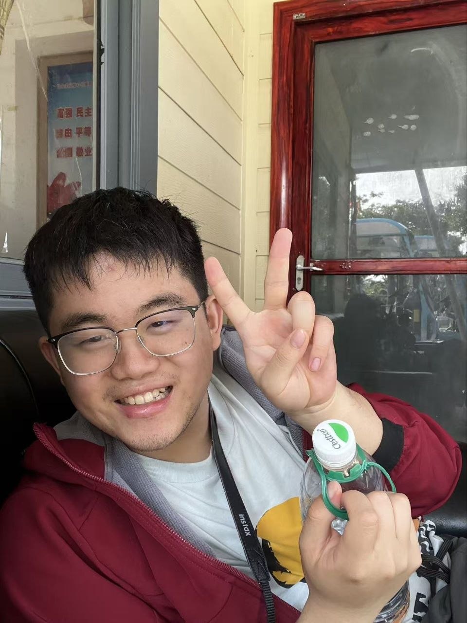 Tong Zhang smiling with a large bottle of water